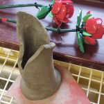 A clay vase for lego roses