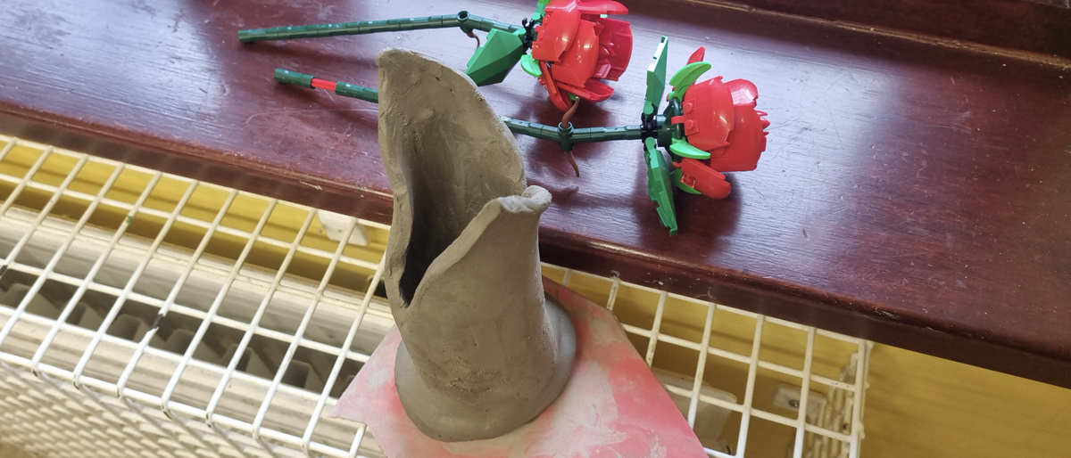 A clay vase for lego roses